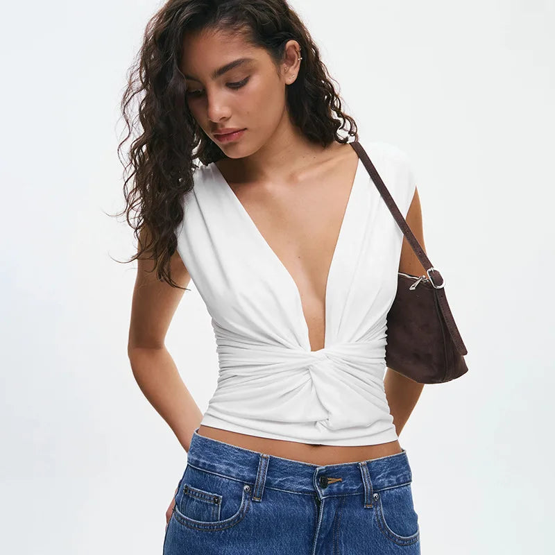 Woman wearing a white top and blue jeans with a brown handbag on a white background