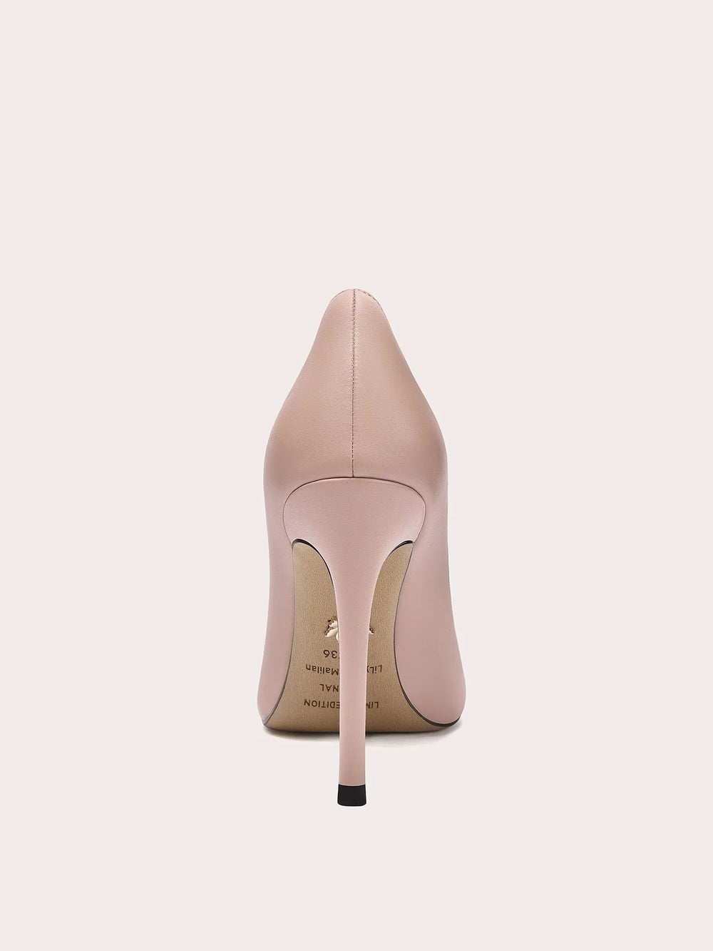 Nude-colored high-heeled shoe on a light beige background