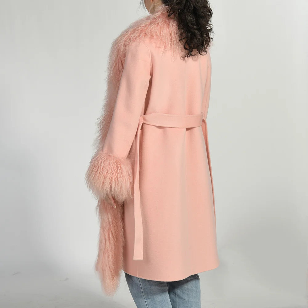 Pink coat with feathered sleeves on a plain background