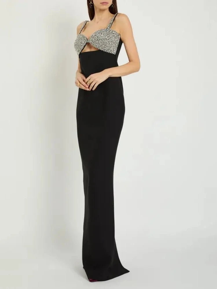 Black evening gown with silver embellishments on a white background