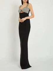 Black evening gown with silver embellishments on a white background