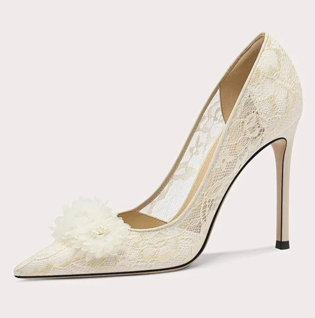 White lace high-heeled shoe on a light gray background