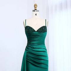 Green evening gown on a mannequin against a white background