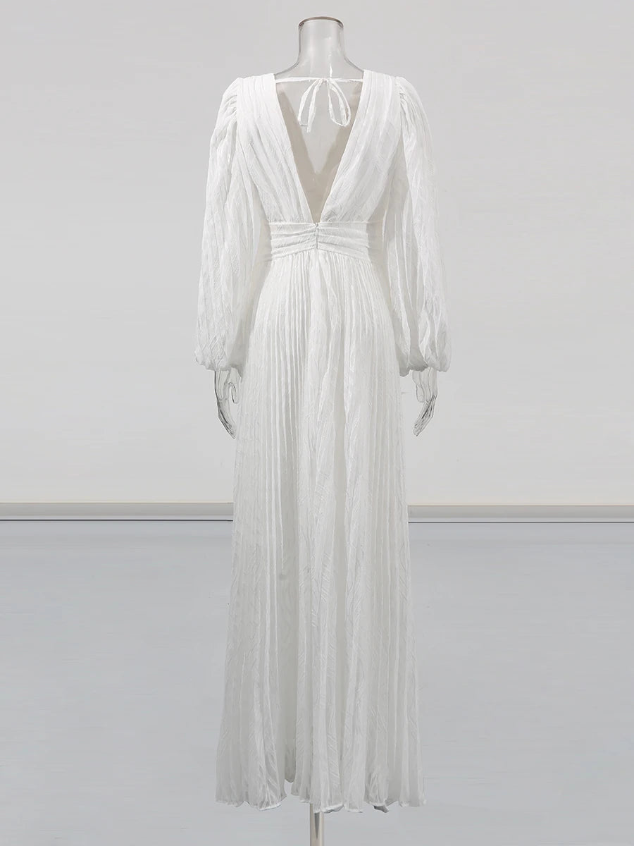 White dress on a mannequin against a plain background