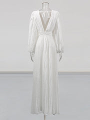 White dress on a mannequin against a plain background