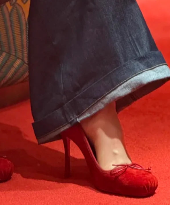 Red high-heeled shoes on a red carpet