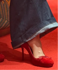 Red high-heeled shoes on a red carpet