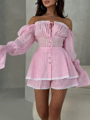 Pink off-shoulder dress with lace details on a neutral background