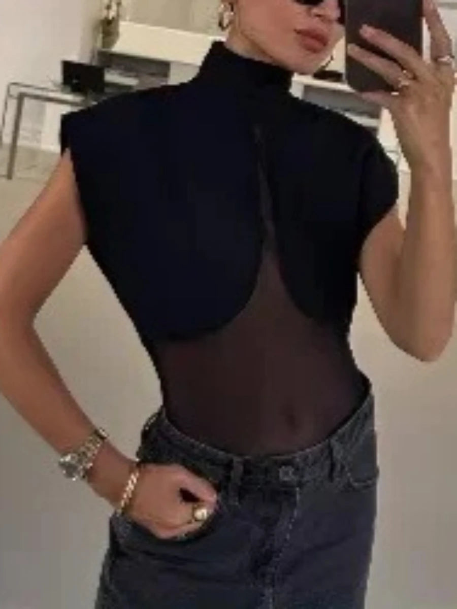 Model wearing high neck mesh patchwork bodysuit with jeans