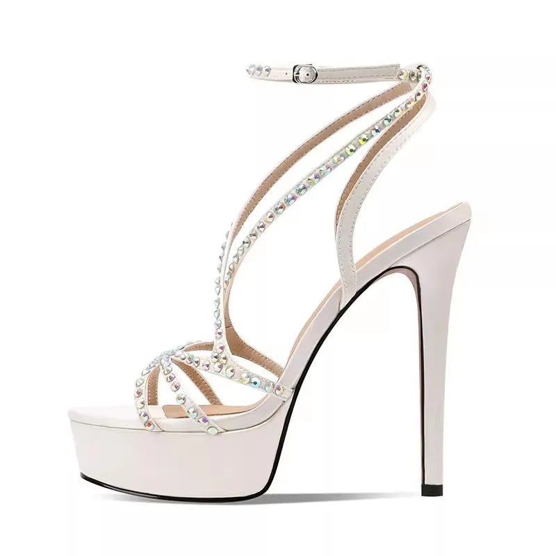 White high-heeled sandal with crystal embellishments on a white background