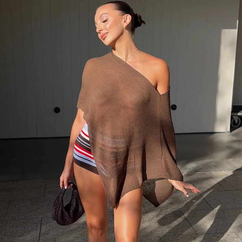 Asymmetrical knit shawl top in brown, worn by a model