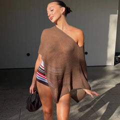 Asymmetrical knit shawl top in brown, worn by a model