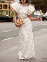 White embroidered lace formal gown with crystal embellishment and puffed sleeves.