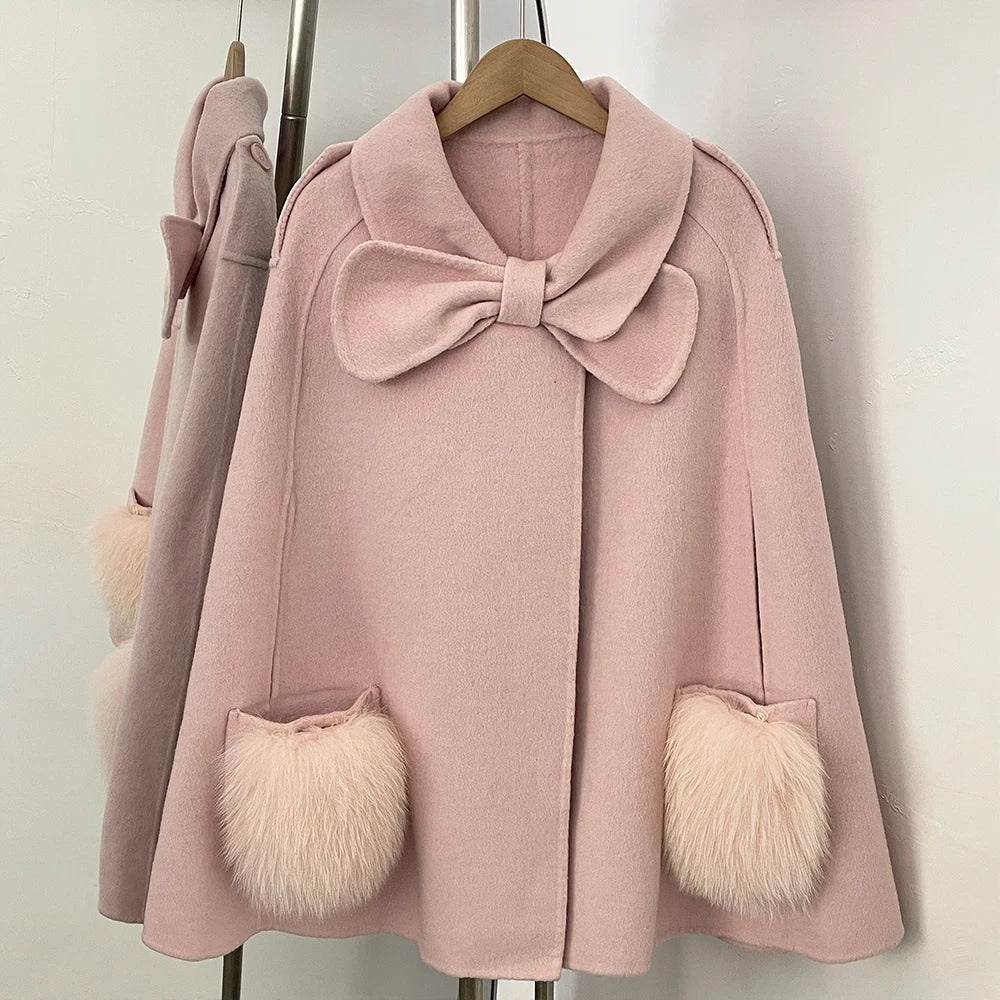 Pink cape coat with bow and fur pockets