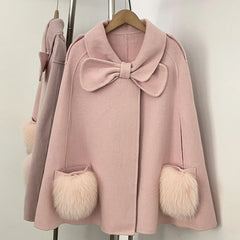 Pink cape coat with bow and fur pockets