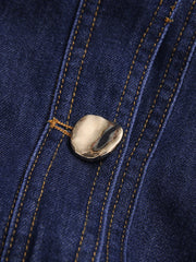 Close-up of a button on a blue denim fabric