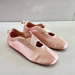 Side view of pink satin ballet flats with crisscross straps