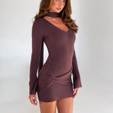 Woman wearing a brown ribbed dress with a knot detail on a white background