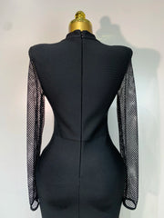 Back view of black knit maxi dress with mesh sleeves