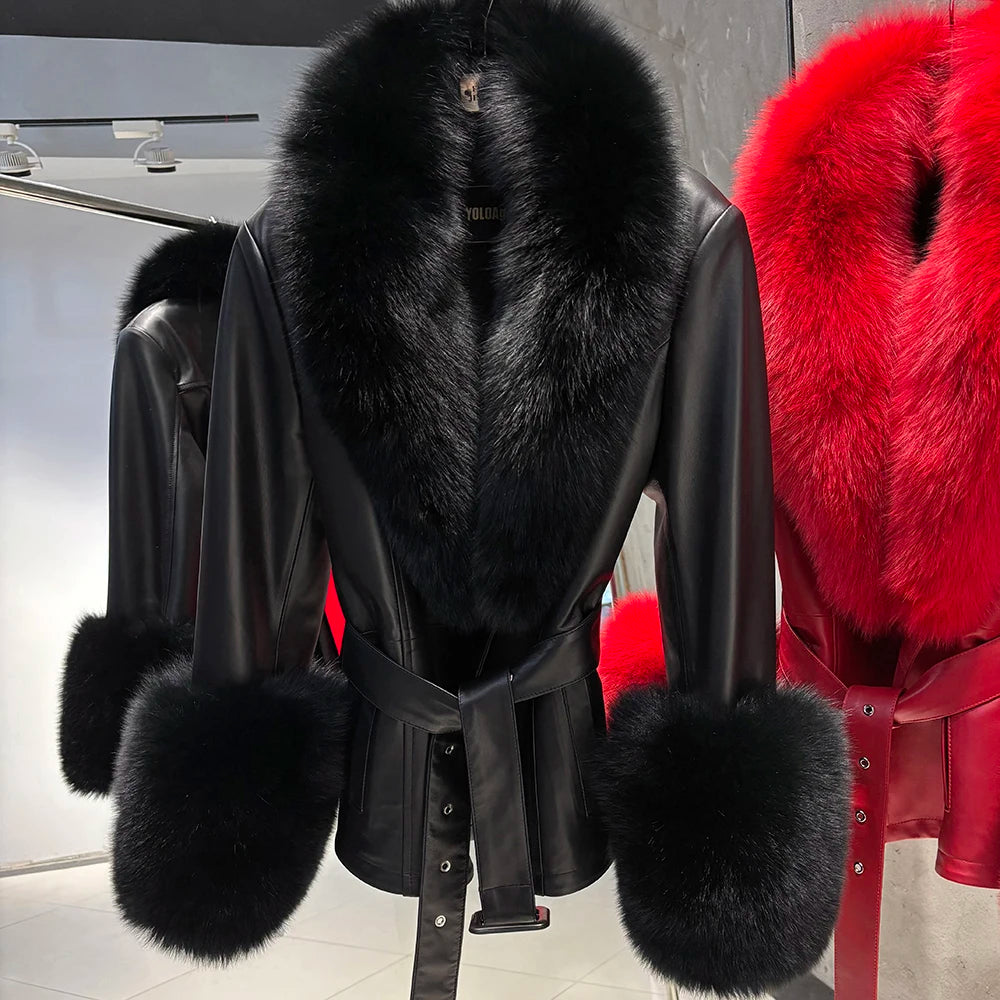 Black leather coat with black fur trim and red fur accents on a rack.
