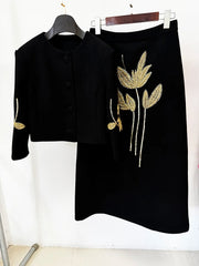 Beaded cropped jacket and midi skirt set hanging on hangers