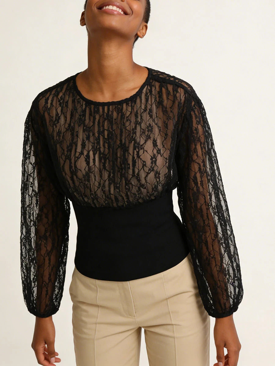 Model posing in black lace long sleeve top