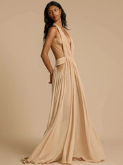Woman wearing a flowing beige dress against a beige background
