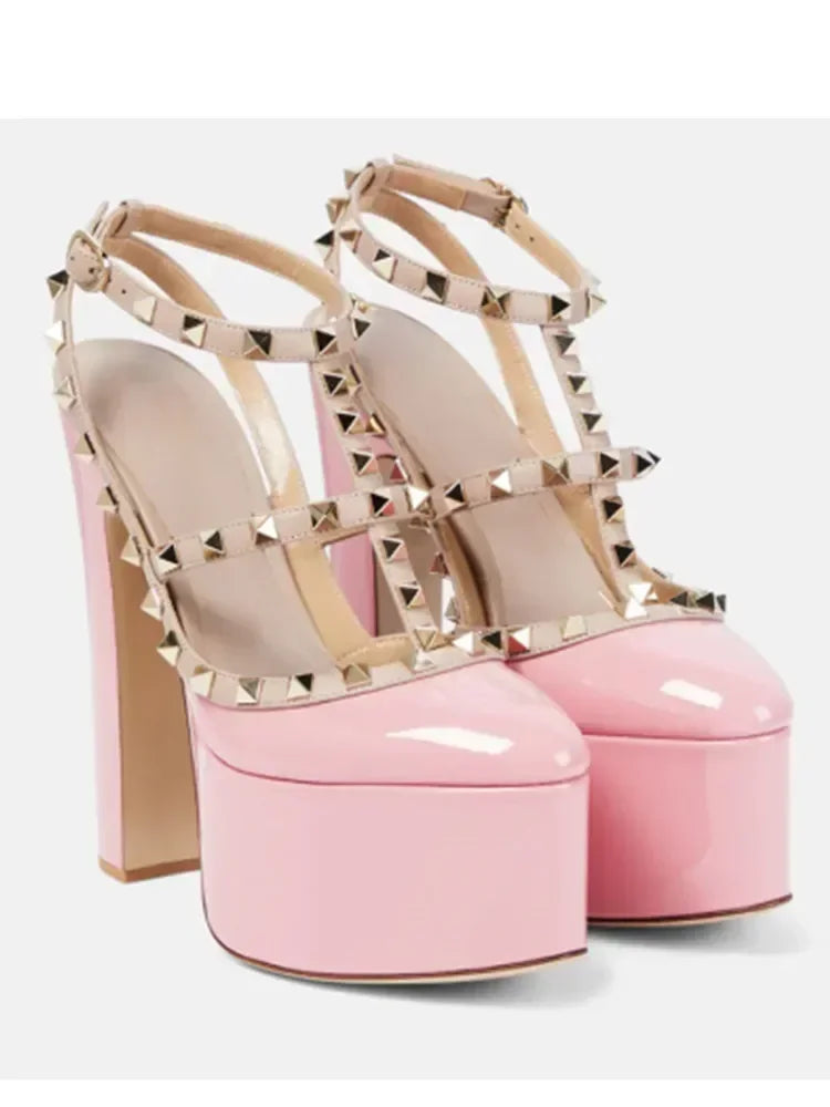 Pink high-heeled platform shoes with gold studded details