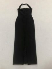 Black dress with embellishments on a light gray background