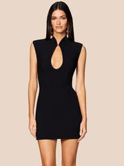 Woman wearing a black dress with a cut-out design on a beige background