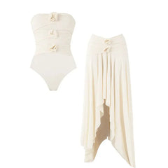 Ruched swimsuit and asymmetrical skirt laid flat
