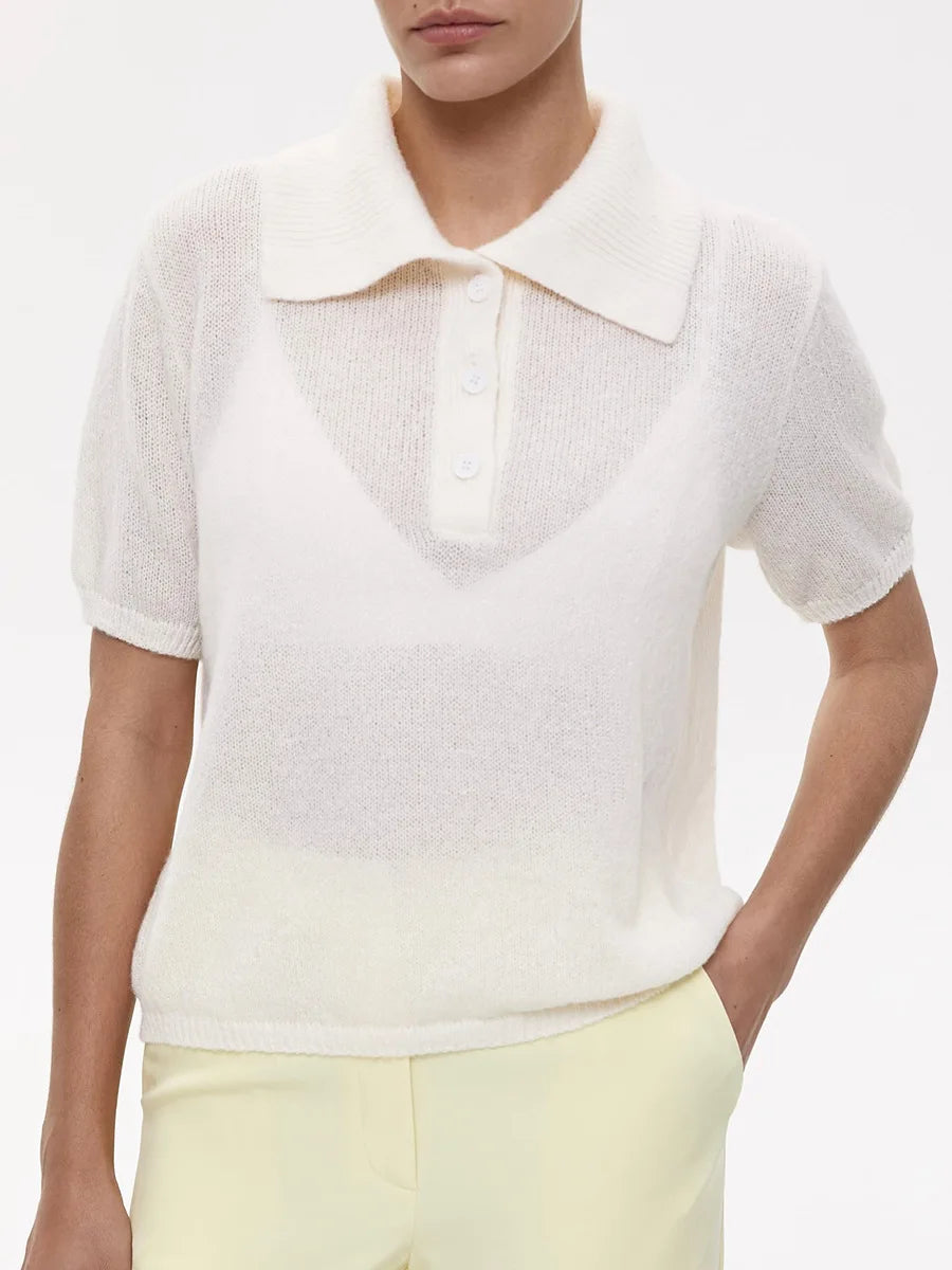 White short-sleeve shirt with a collar worn by a person on a white background