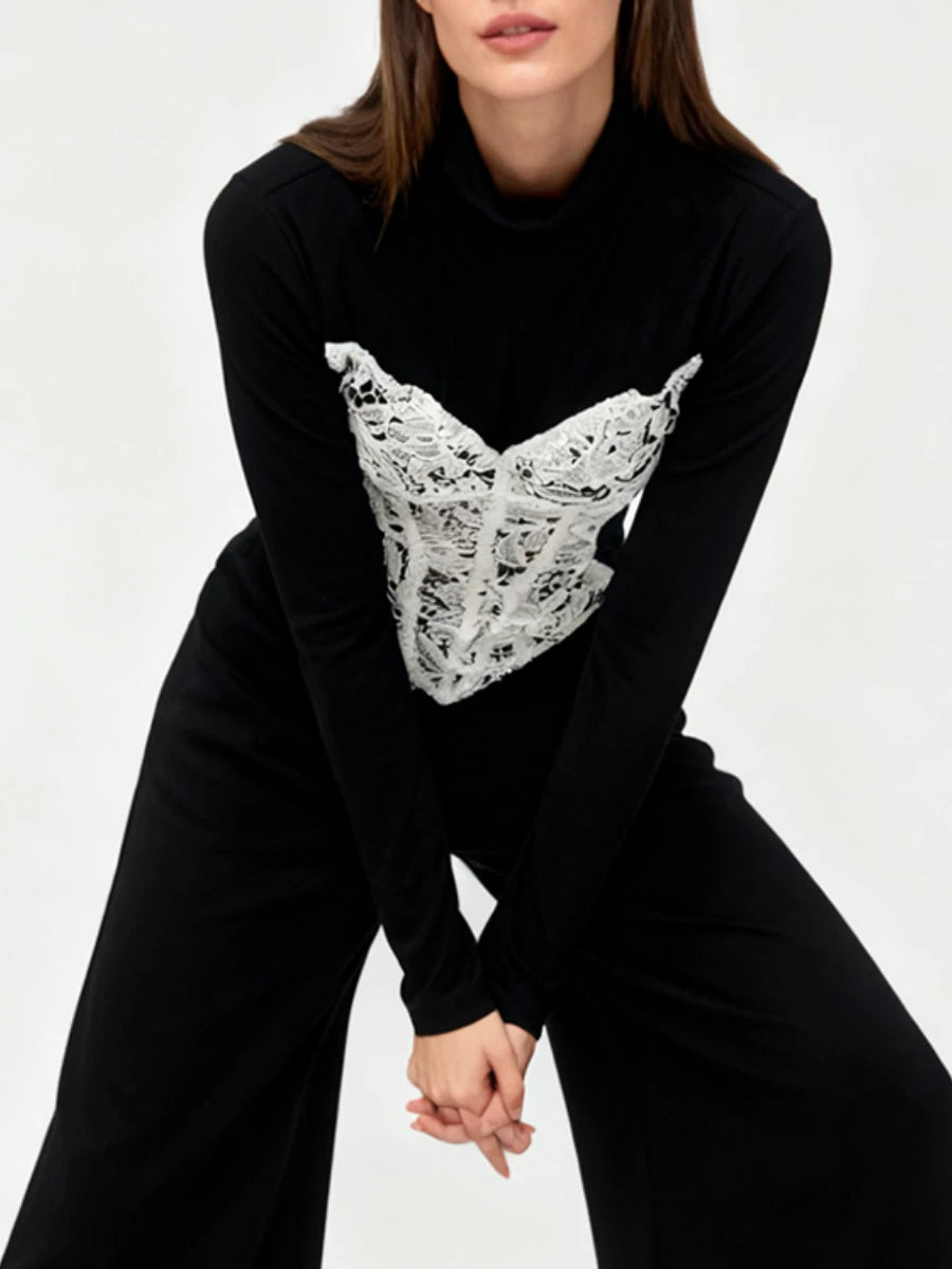 Black turtleneck sweater with lace detail on a white background