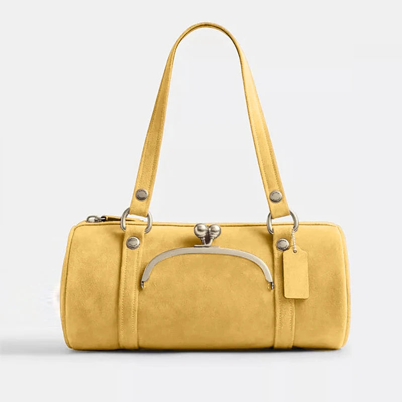 Yellow handbag with a silver clasp on a light gray background
