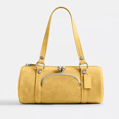 Yellow handbag with a silver clasp on a light gray background