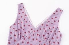Close-up of the V-neckline and lace trim on the lilac floral midi dress