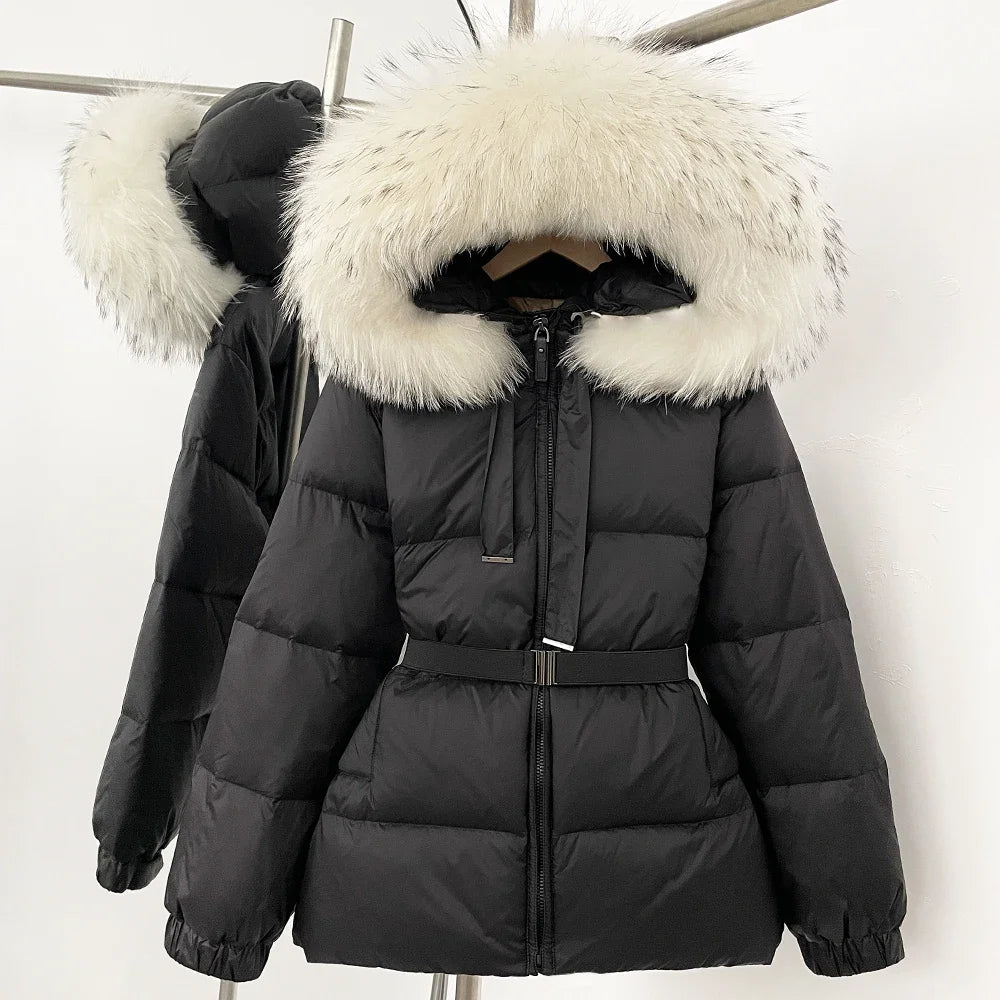 Black puffer jacket with white fur hood on a hanger against a white background