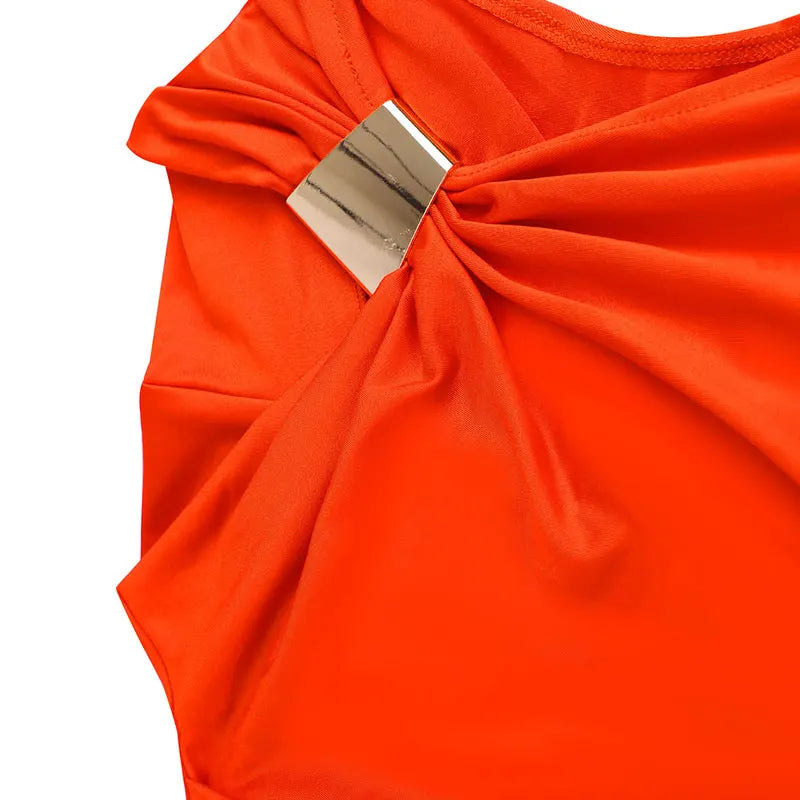 Close-up of an orange top with a metal clasp on a white background