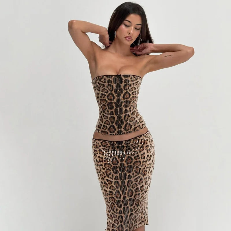 Woman wearing a leopard print strapless dress on a plain background