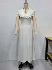 White dress with lace details on a mannequin against a white background