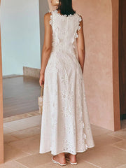 Woman wearing a white lace dress in an outdoor setting