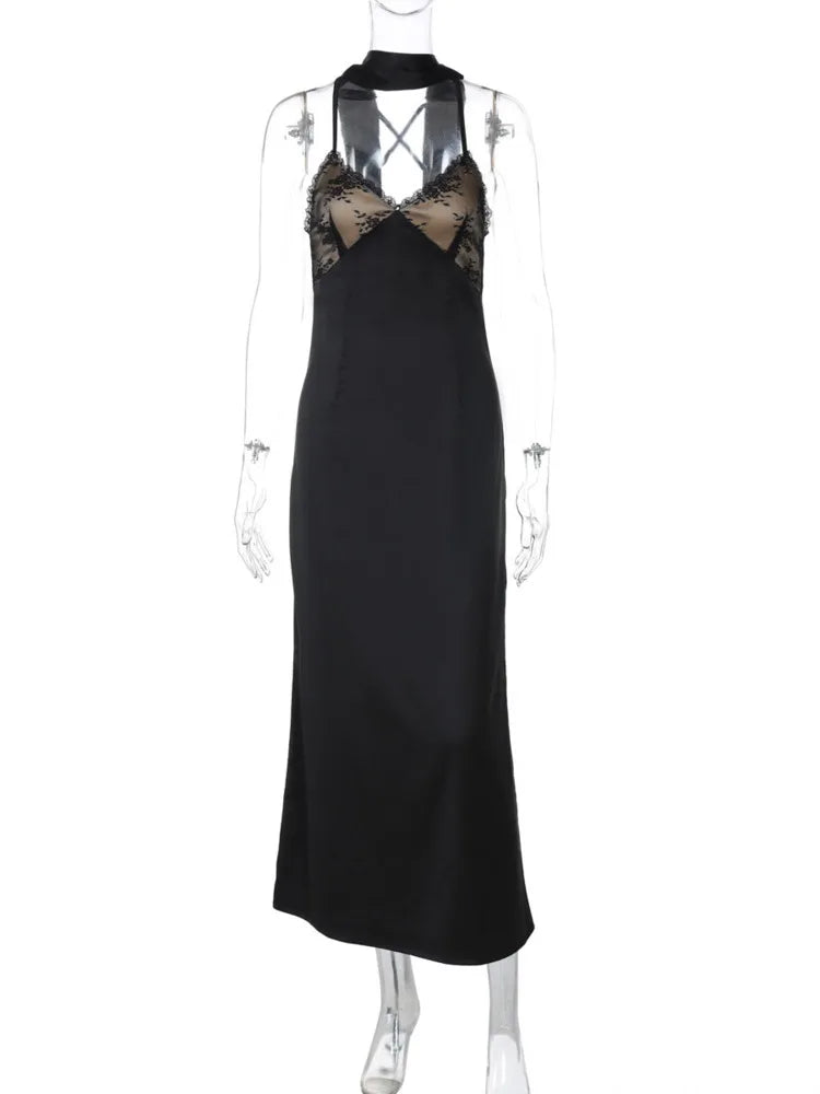 Black evening gown with intricate beaded neckline on a mannequin against a white background
