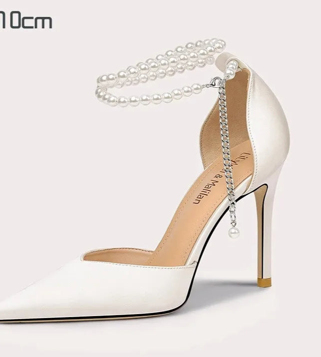 White high-heeled shoe with pearl chain on a white background
