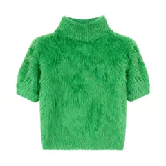 Green fluffy sweater on a white background