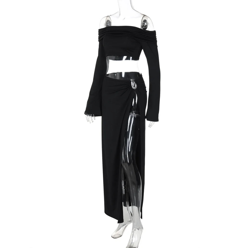 Black off-shoulder top and long skirt with sheer panels on a mannequin against a white background