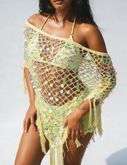 Yellow sequin knit poncho with fringe hem worn by a model.
