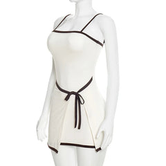 White dress with black trim on a mannequin against a white background