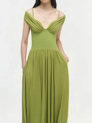 Green dress worn by a model on a white background