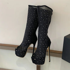Close-up of black mesh peep toe knee-high platform boots with crystal embellishments