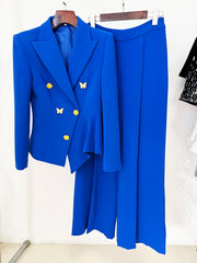 Blue double-breasted blazer suit with asymmetrical peplum and flare trousers displayed on a hanger.